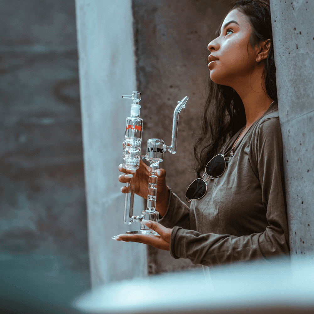 girl holding glass bong